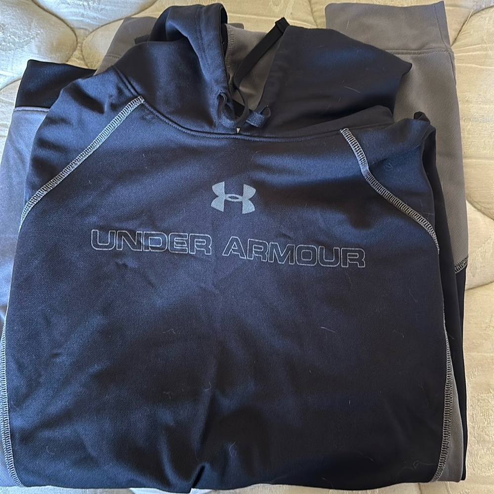 Black and grey men’s under armour heat gear hoodie.